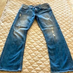 Brand new, faded and distressed GUESS jeans. Size 33x30 falcon-regular boot
